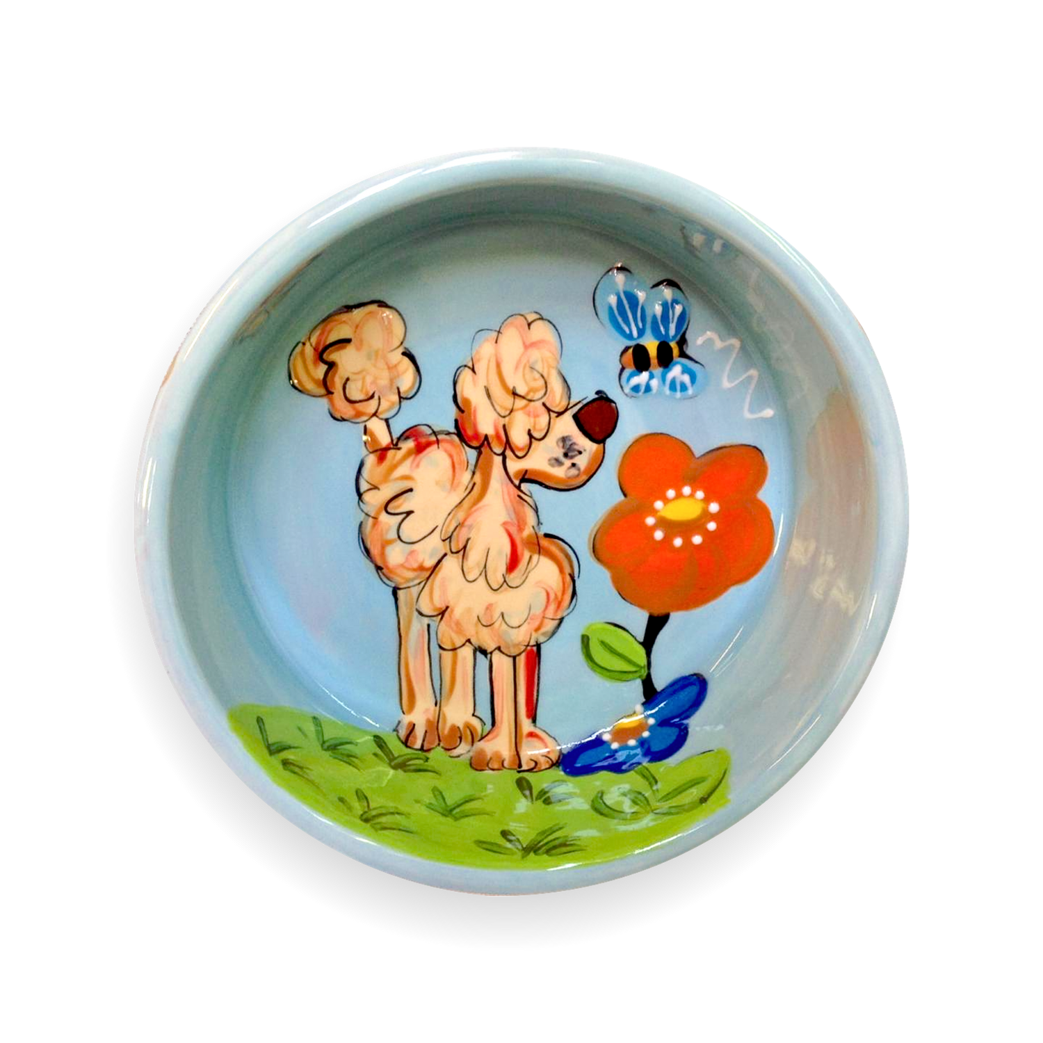 Hand-painted ceramic bowl featuring a whimsical depiction of a tan poodle with stylized fluffy fur standing next to a large red flower with a yellow center. The poodle is adorned with a brown beret and looks curiously at a pair of blue butterflies above its head. The scene is set against a light blue background, suggesting a clear sky, with a green grassy base indicating the ground.