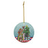 Animated dogs playfully trying to reach a star on a Christmas tree, set against a light blue background with subtle snowflakes, as part of a circular holiday ornament with a golden hanging string.