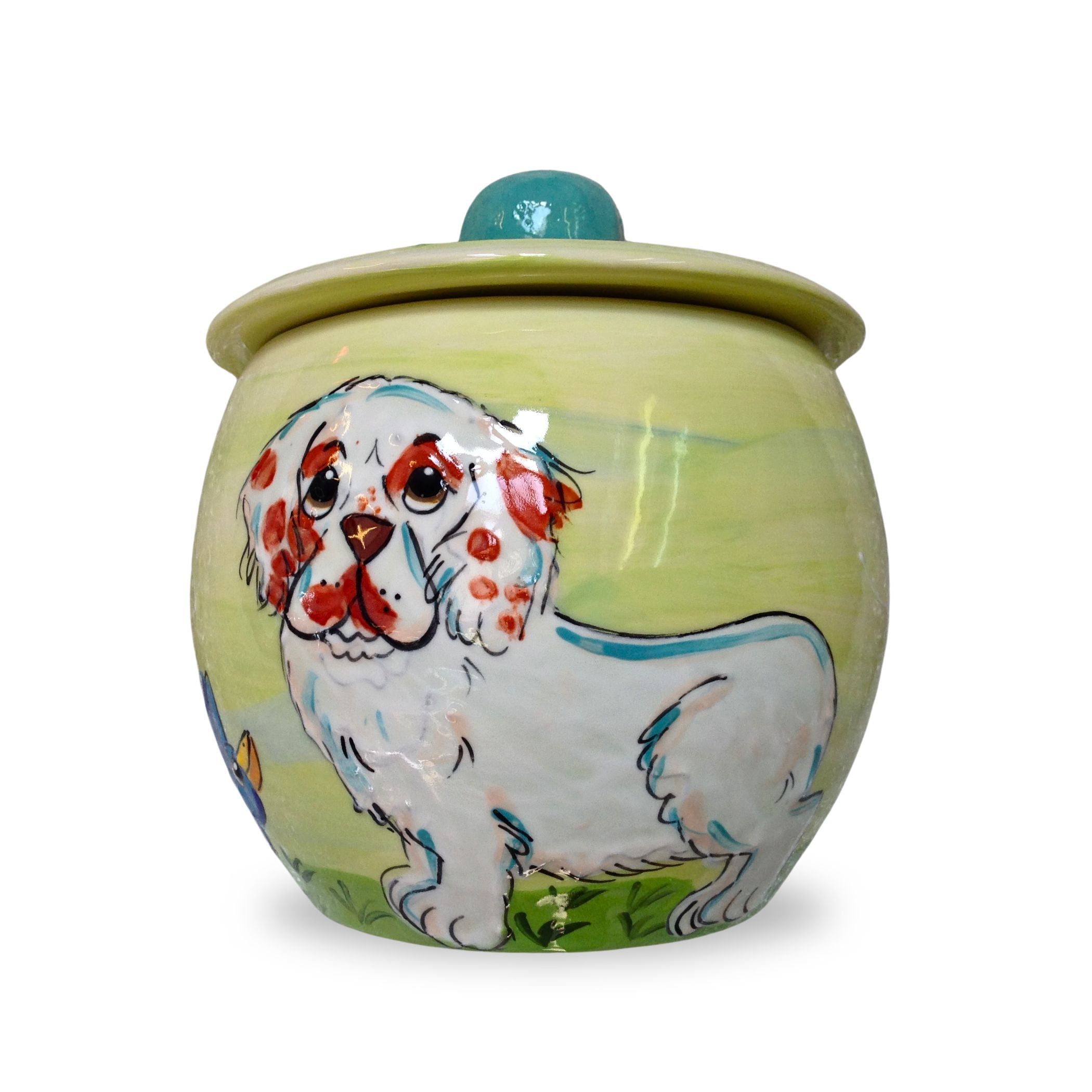 Hand-painted Clumber Spaniel Dog treat jar with a green gradient and blue lid detail by Debby Carman.