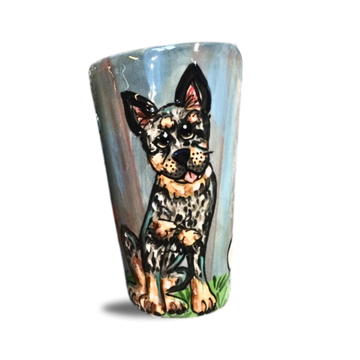 A 16 oz mug painted with an attentive Australian Cattle Dog, set against a calming blue background, capturing the breed&