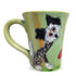 A 12 oz mug featuring a hand-painted Chinese Crested Dog, with a light green background and a gentle yellow handle, created by Debby Carman.