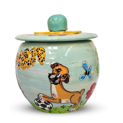 Artisanal treat jar painted with a frolicsome dog, leopard spots, and whimsical insects, topped with a pastel blue lid adorned with a sunny yellow accent