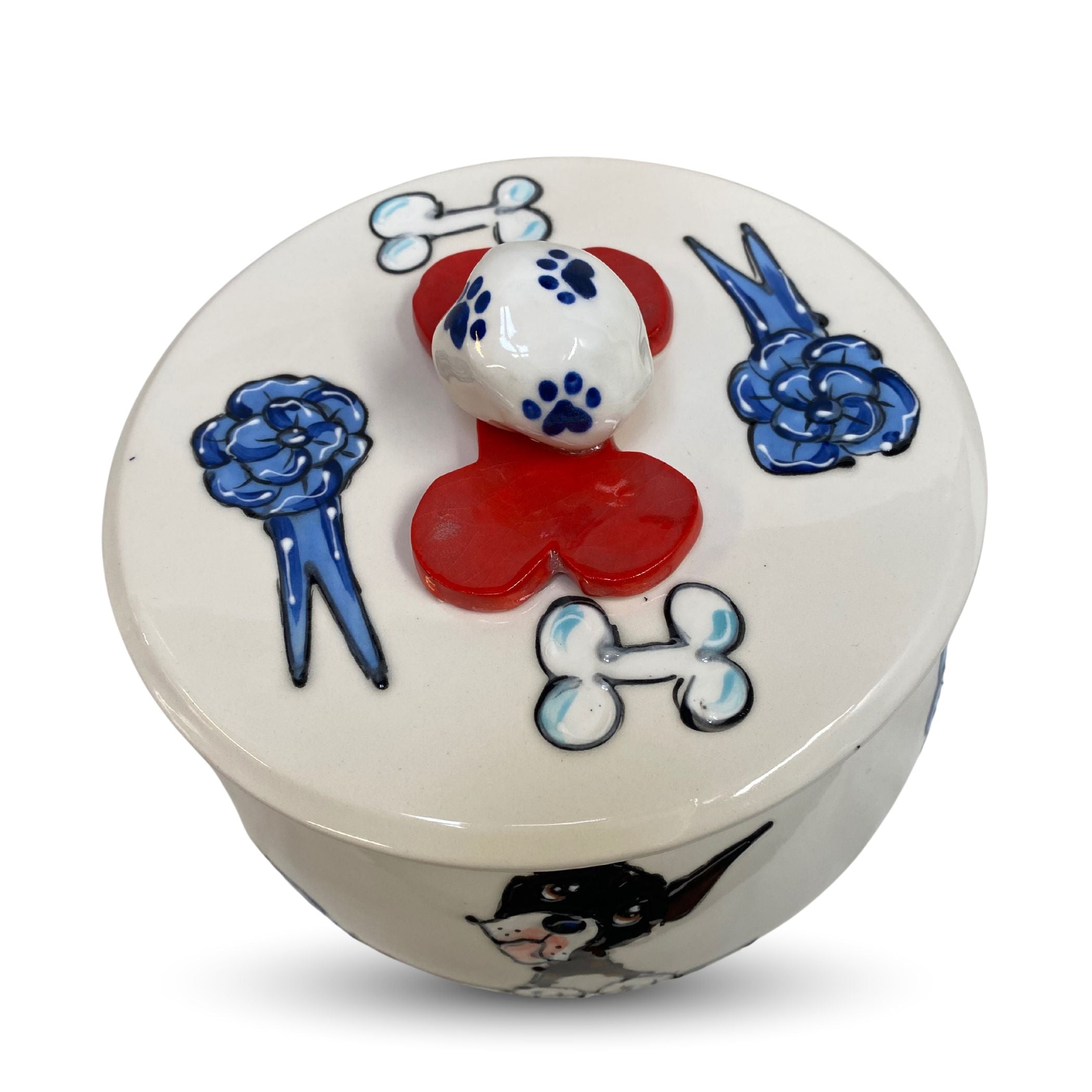 Top view of a ceramic dog treat jar with hand-painted paw and bone motifs on lid - microwave safe from Faux Paw.