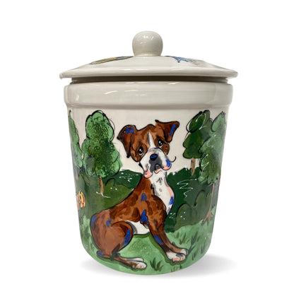 Custom-crafted treat jar showcasing a boxer dog sitting amidst greenery, with intricate hand-painted details and a round lid on top