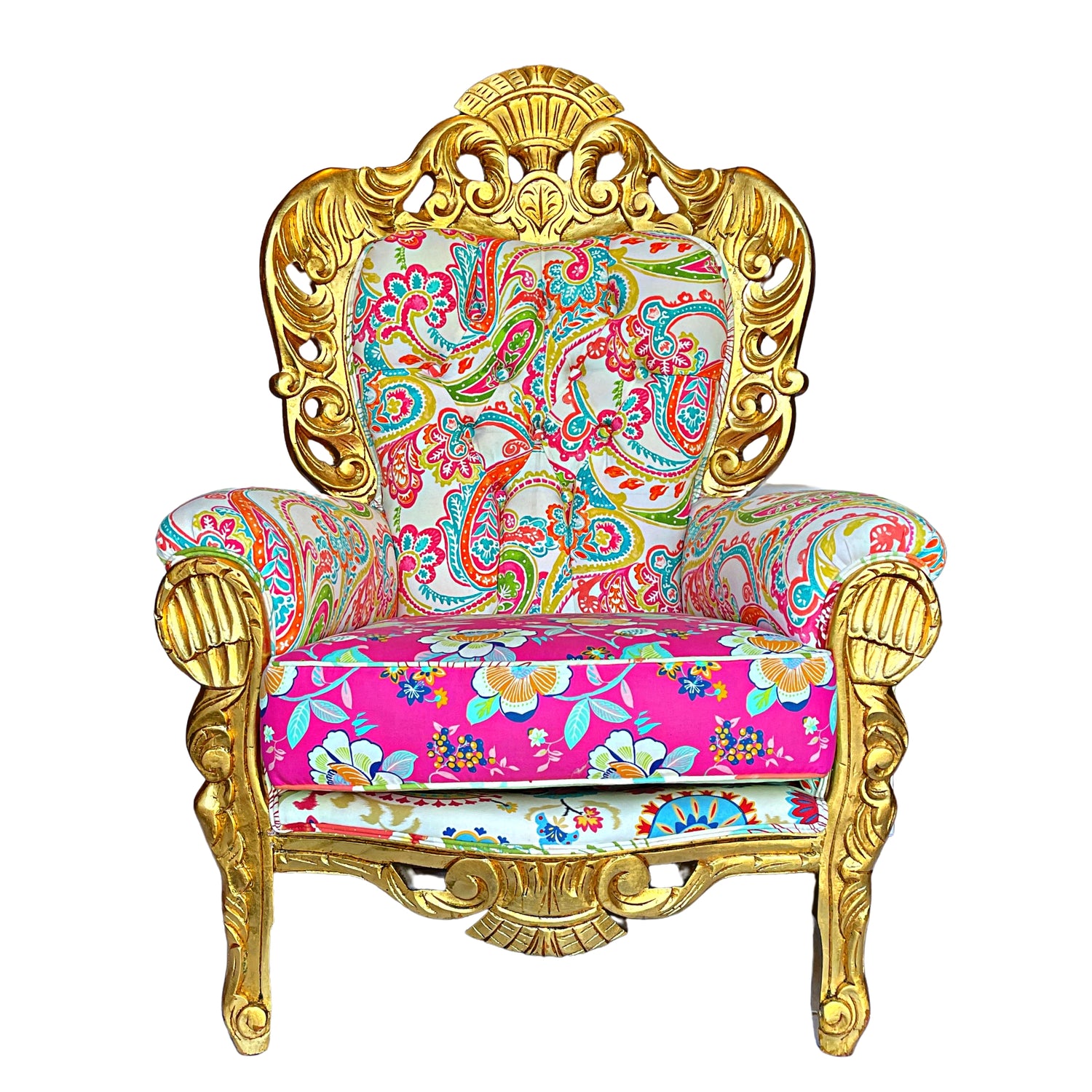 Frontal view of a luxurious baroque armchair with a glossy gold frame, adorned with elaborate carvings and upholstered in a bright paisley and floral pattern with pink, turquoise, and gold colors