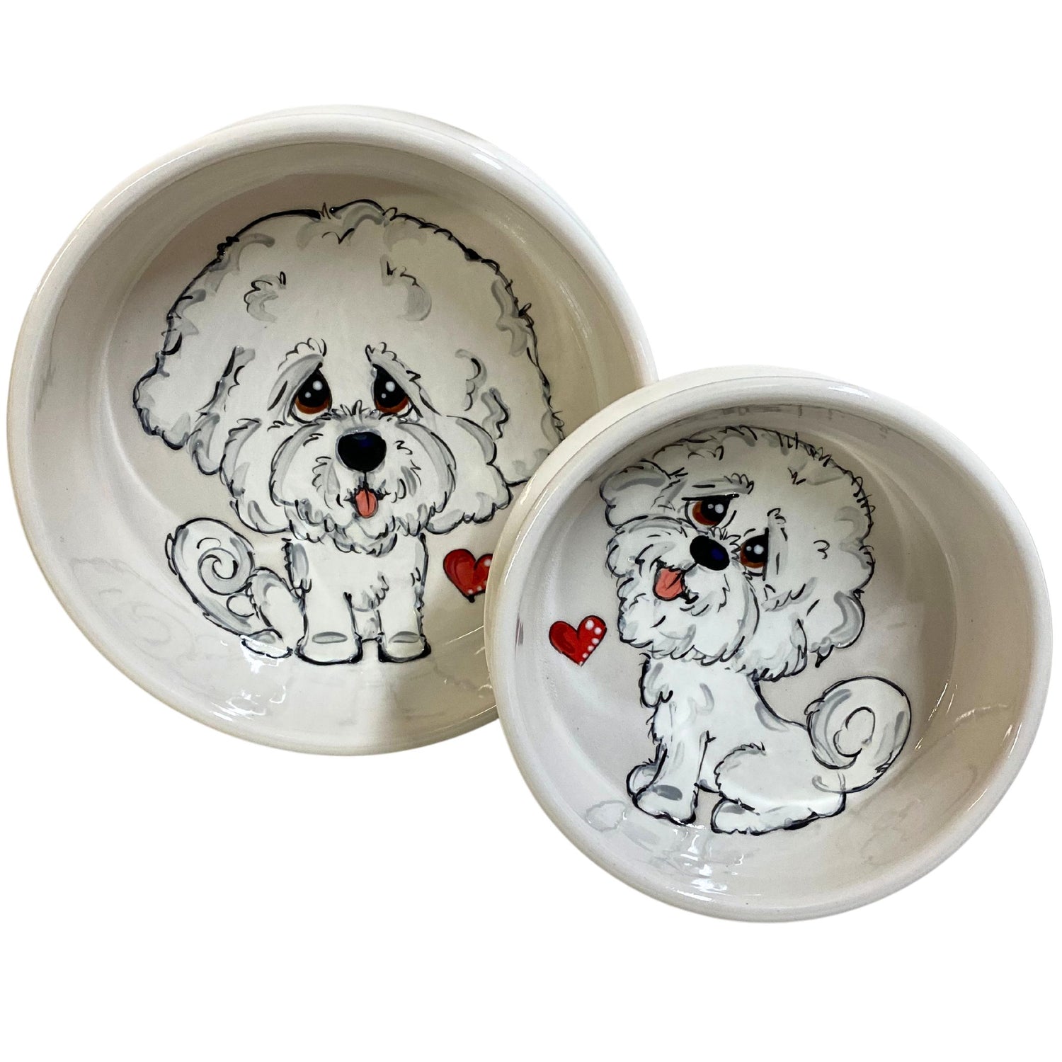 A set of two ceramic bowls with a hand-painted Bichon Frise dog, the smaller 6&quot; bowl for food and the larger 8&quot; bowl for water, each with cute red heart details.