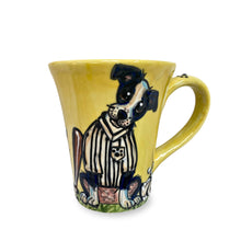 A 12 oz coffee mug with a whimsical hand-painted Border Collie in a referee's outfit, on a bright yellow background, designed by Debby Carman.