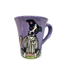 A 12 oz coffee mug featuring a hand-painted illustration of a Border Collie in a black and white referee's uniform, set against a soft lavender background with a matching purple handle.