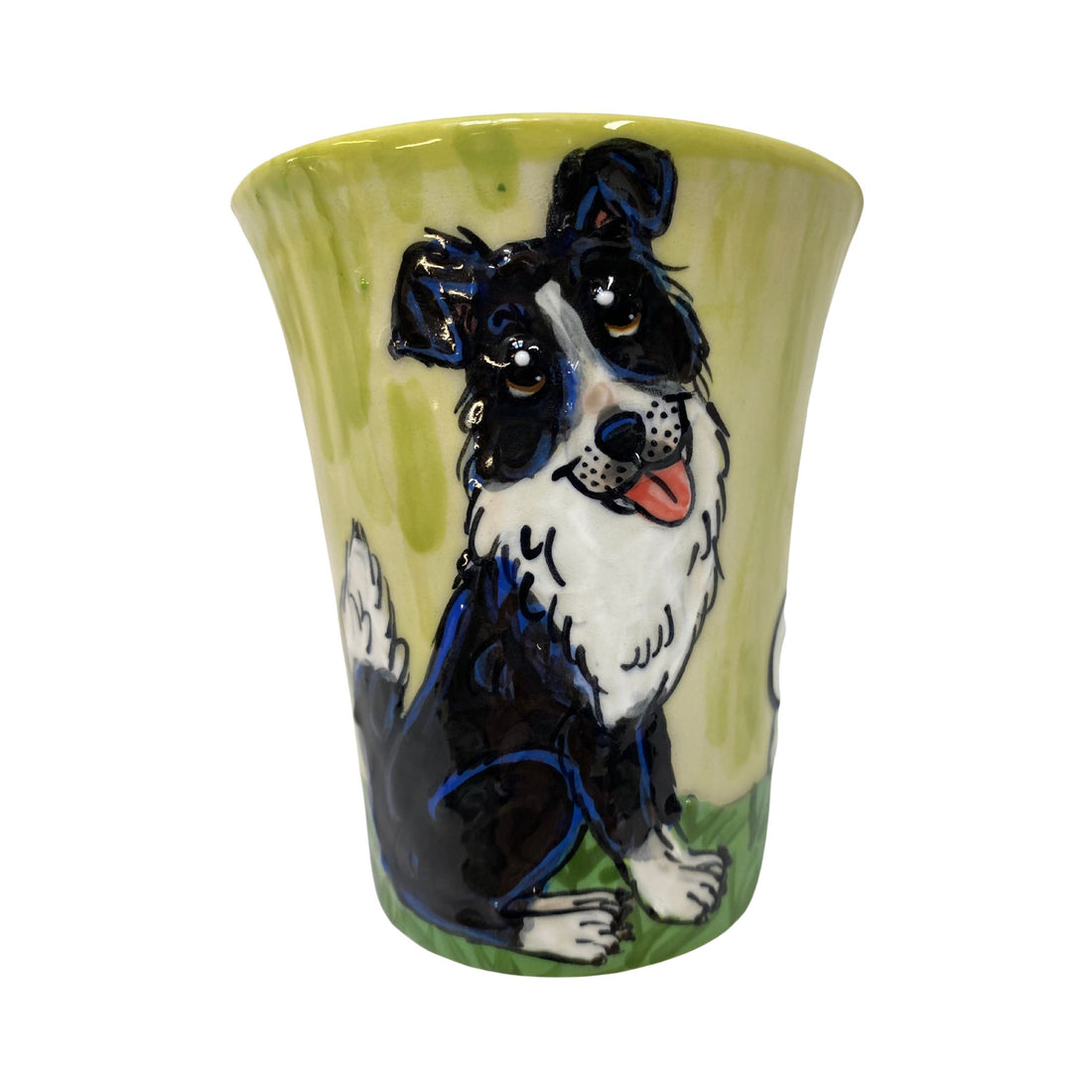 Hand-painted ceramic mug featuring a lively Border Collie on a bright green background, capturing the dog&