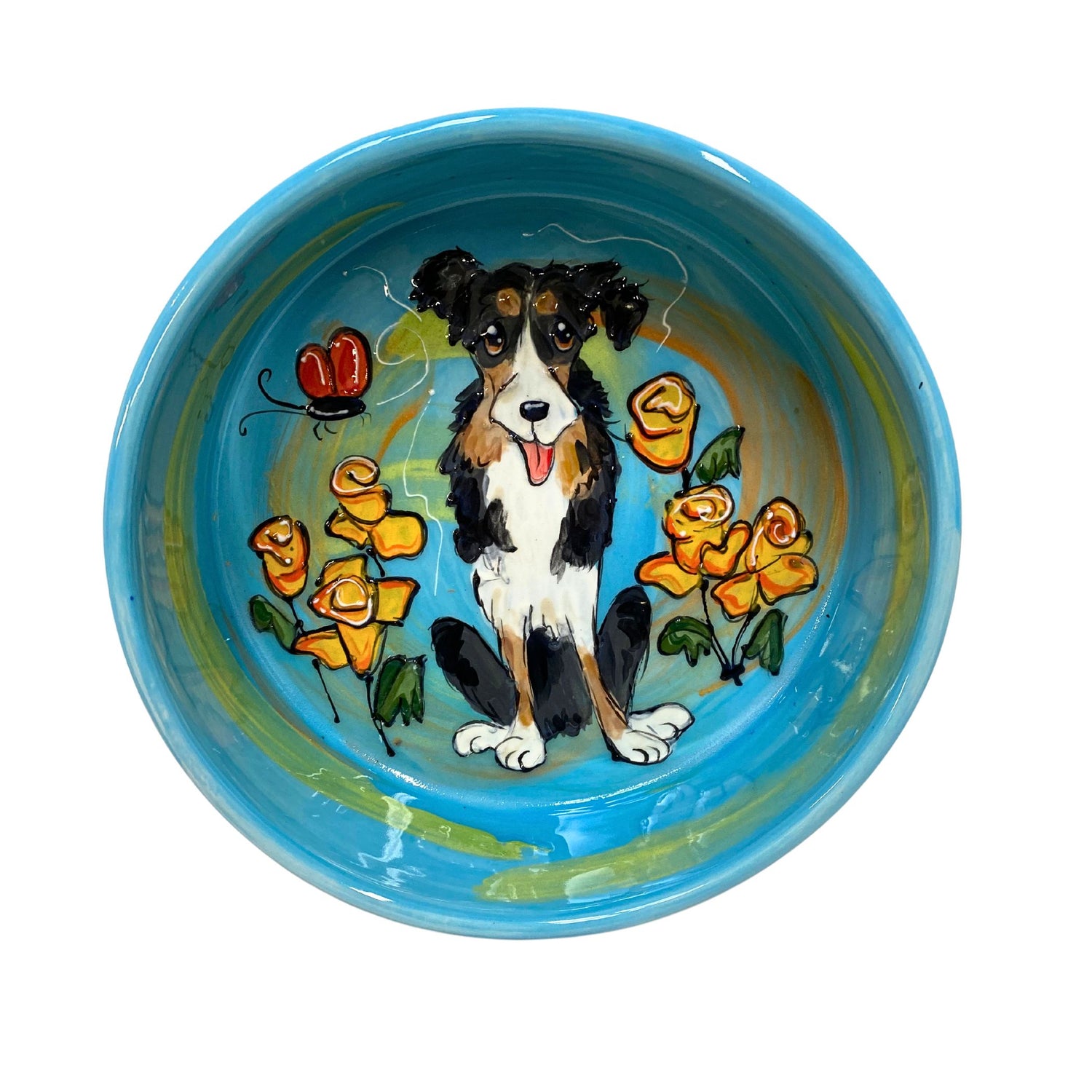 A hand-painted ceramic bowl showcasing a Border Collie surrounded by orange flowers against a blue background, from the &quot;Floral Fido&quot; Collection, available on FauxPaw.com