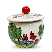 Faux Paw's Boxer-themed ceramic jar, beautifully adorned with floral and fauna illustrations, perfect for dog show awards.