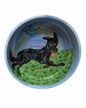 Shepherd and birdie in a patch of marigolds