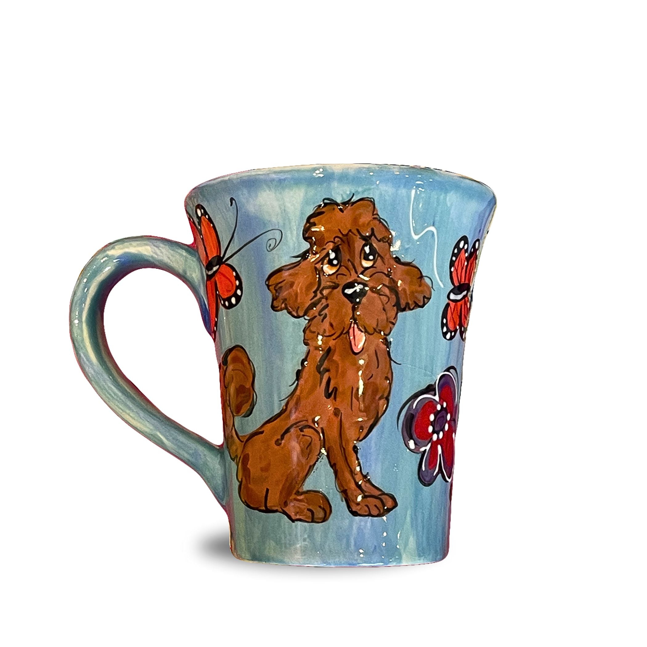 Hand-painted 12oz ceramic mug featuring a Miniature Doodle with whimsical butterflies and flowers on a soothing blue background, perfect for nature and dog enthusiasts