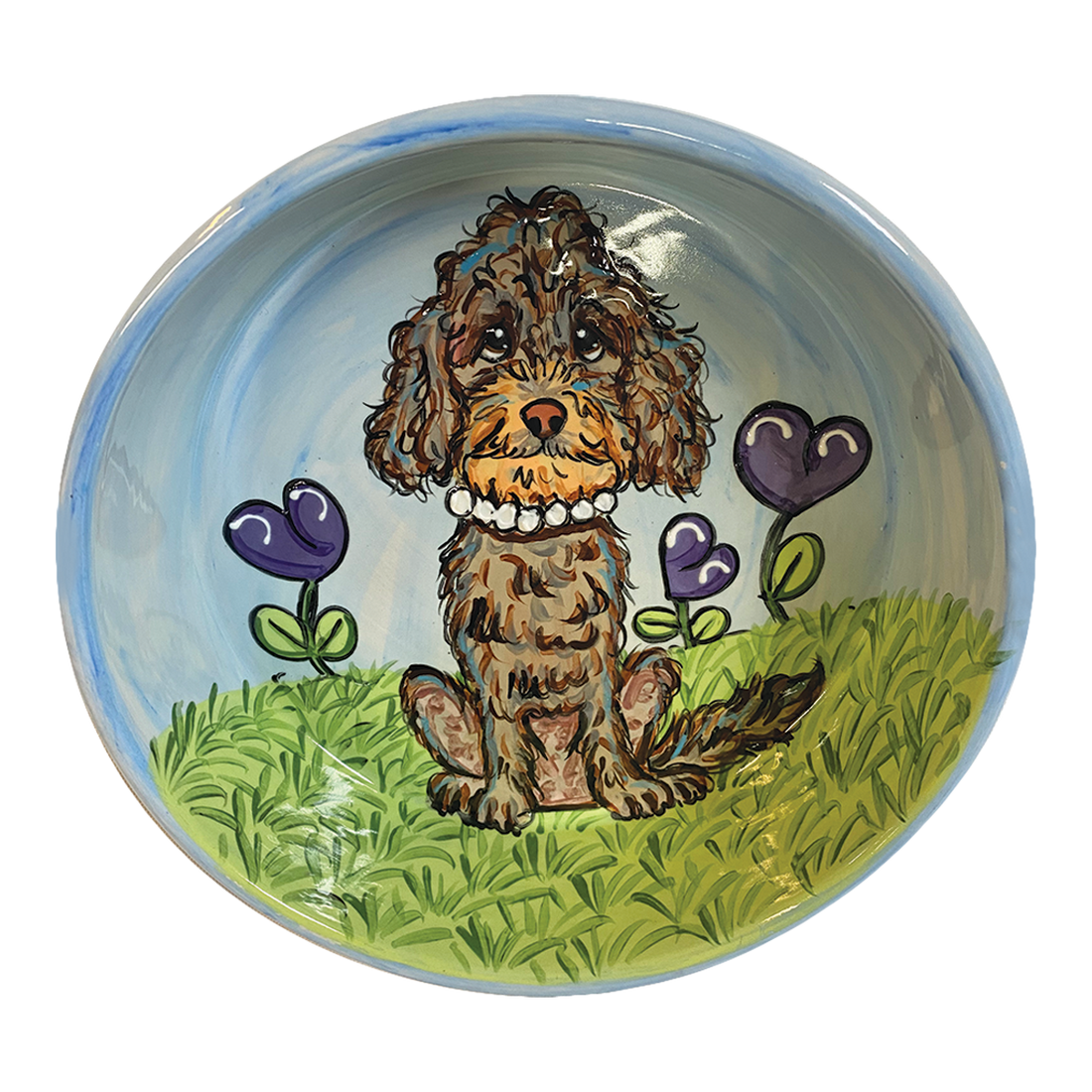 Charming hand-painted ceramic bowl with a glossy finish, depicting a brown poodle sitting in a vibrant green grassy field with purple heart-shaped flowers. The background transitions from the greenery of the field to a serene blue sky, creating a picturesque garden setting that exudes a loving, homely vibe.