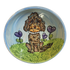 Charming hand-painted ceramic bowl with a glossy finish, depicting a brown poodle sitting in a vibrant green grassy field with purple heart-shaped flowers. The background transitions from the greenery of the field to a serene blue sky, creating a picturesque garden setting that exudes a loving, homely vibe.