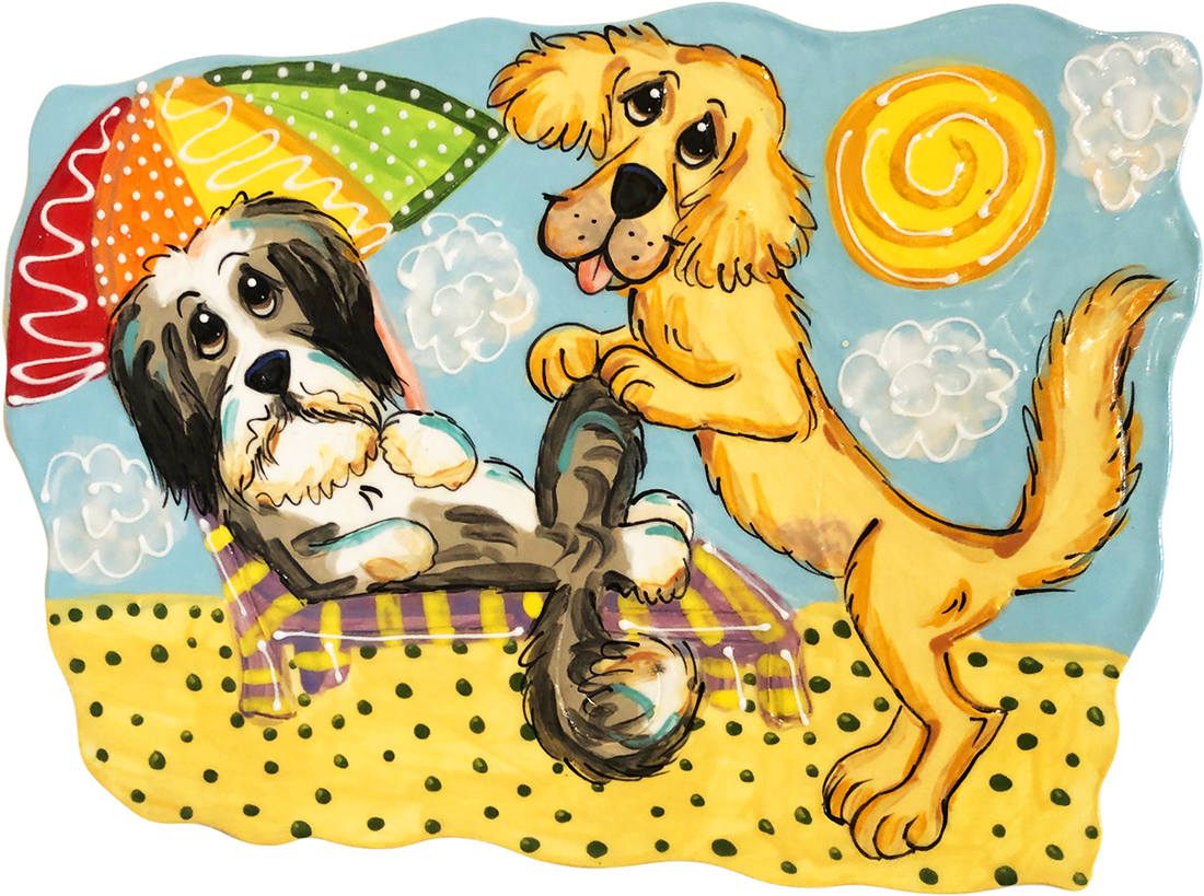 Hand-painted ceramic tile showing a Golden Retriever standing with a leash and a Bernese Mountain Dog lying under a colorful umbrella on a beach, by artist Debby Carman