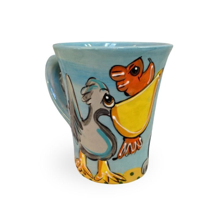 Rear view of a ceramic mug with a colorful seagull painted on a matching light blue background, complementing the seaside theme.