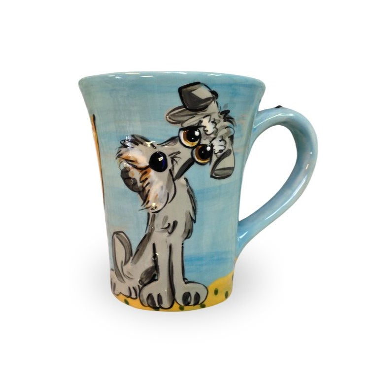 Hand-painted ceramic mug featuring a dapper Schnauzer with a hat and monocle on a light blue background.