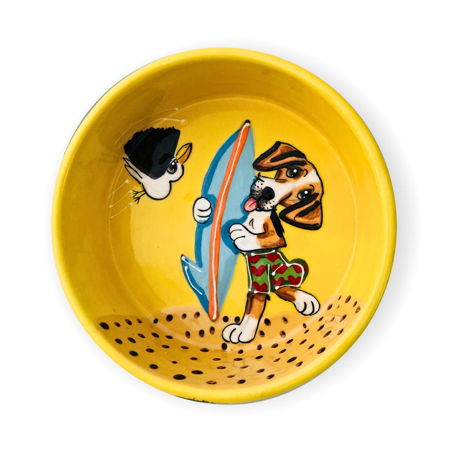 Hand-painted personalized ceramic beagle food and water bowl with a fun depiction of a beagle in surf shorts holding a surfboard, with a sneaky cat peeking from the side, all on a vibrant yellow background.