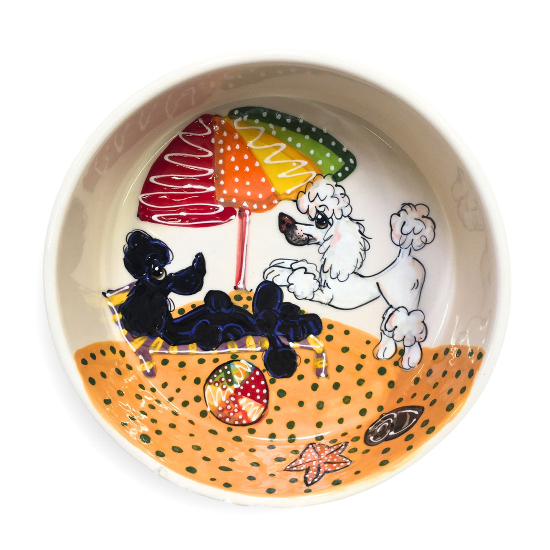 Handcrafted ceramic pet bowl with a hand-painted beach scene featuring two poodles, one black and one white, under colorful beach umbrellas on a sandy beach background with seashells and starfish details