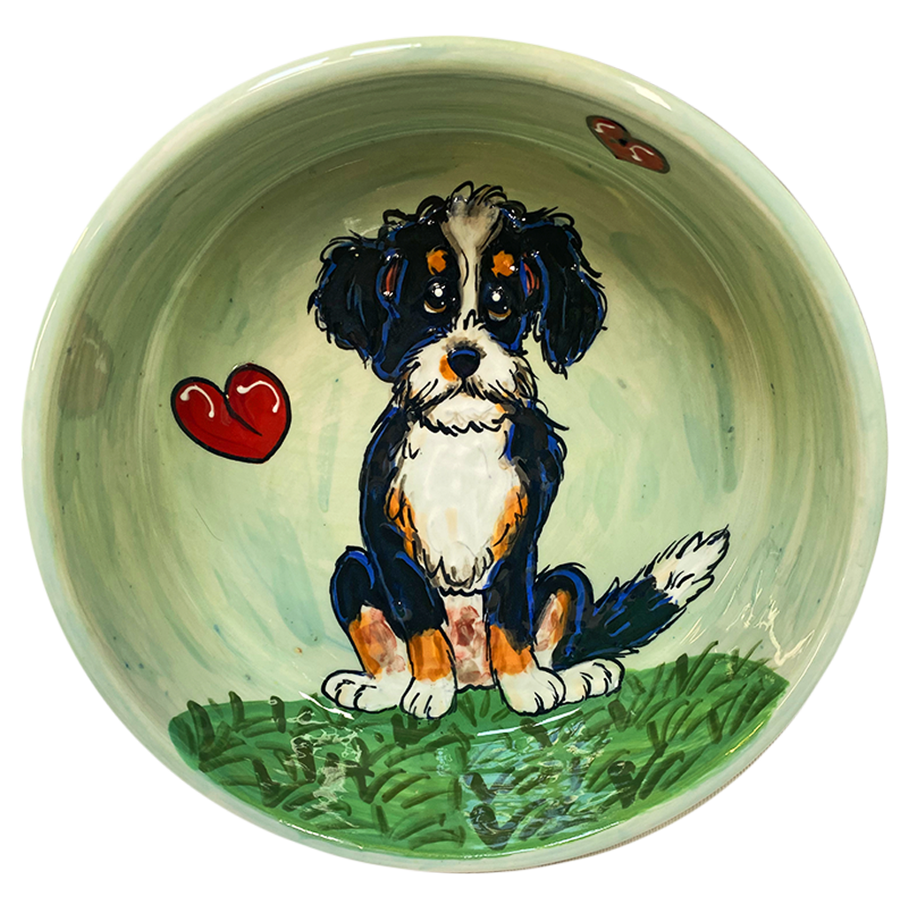 image of whimsical bernadoodle painted on ceramic pet bowl by debby carman