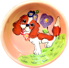 Sweet King Charles Blenheim sitting in flowers dog bowl