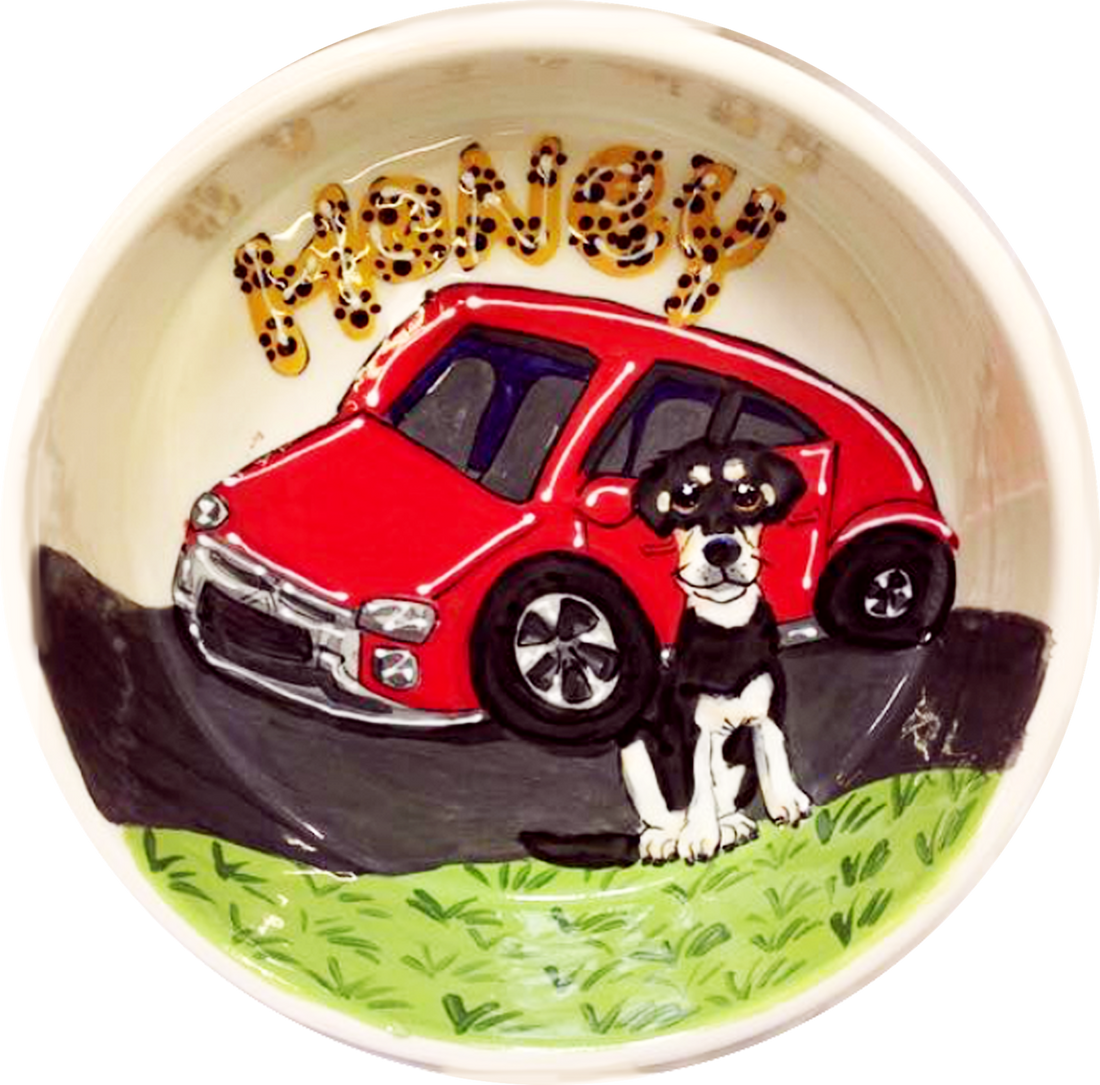 photo of black and white mix breed dog with red car on ceramic dog bowl 