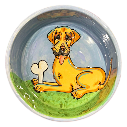 Labrador holding dog bone portrait on blue ceramic bowl