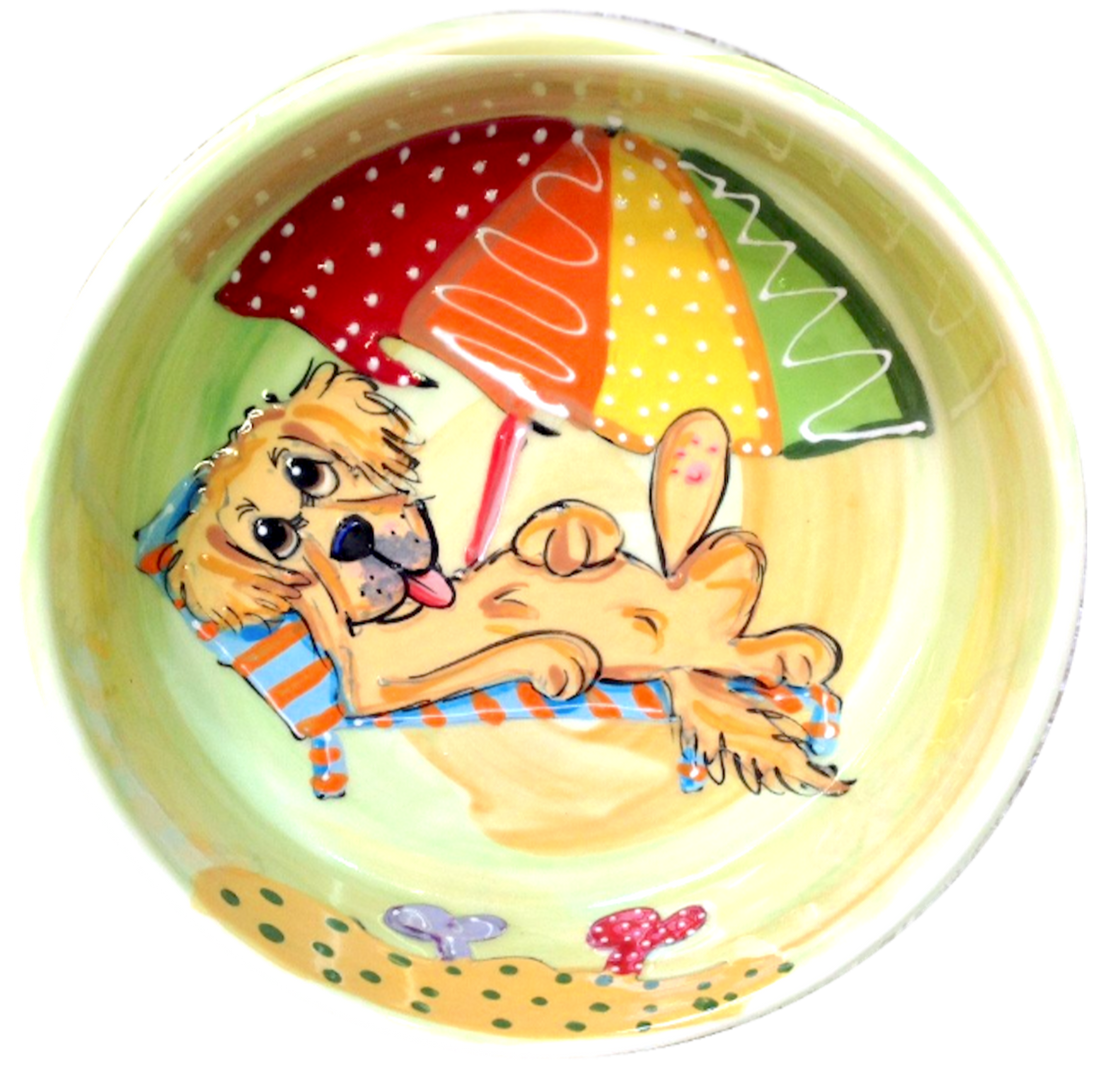 Dog Friendly Beach Golden Retriever relaxing in the sand on yellow ceramic dog bowl