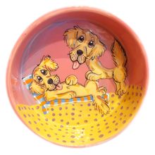 Photo of two golden retrievers hand painted by Debby Carman, on a 8' ceramic dog bowl, pink color background, beach theme